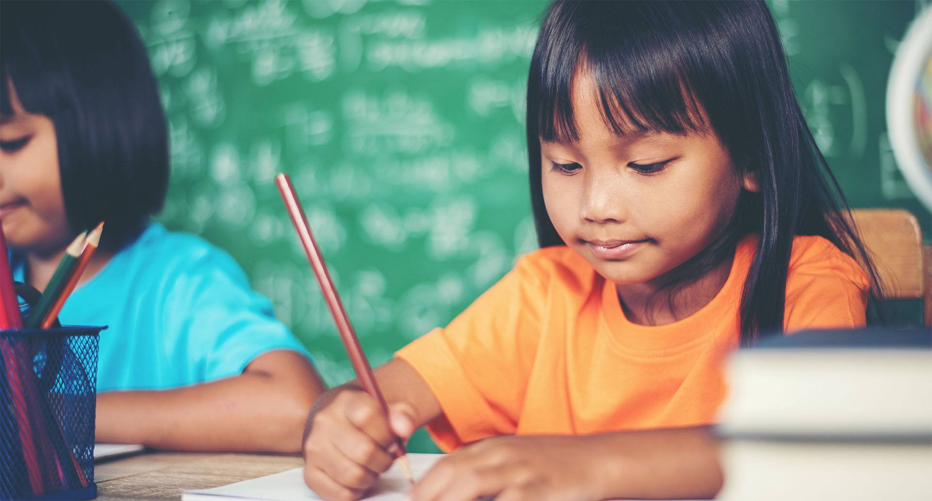 Little girl studying in class