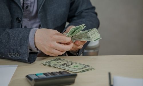 Man counting a huge stack of cash