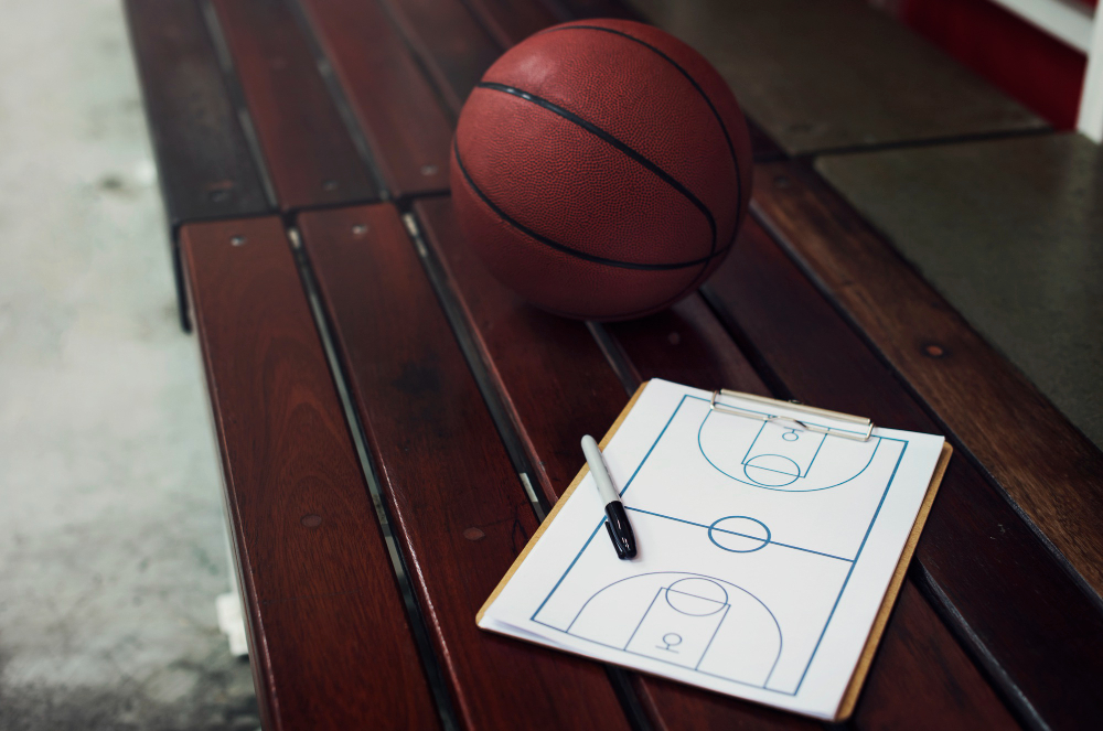 Basketball and clipboard sitting on bench