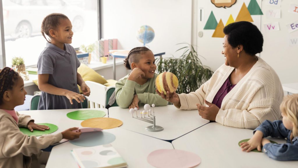 kids learning with teacher in classroom